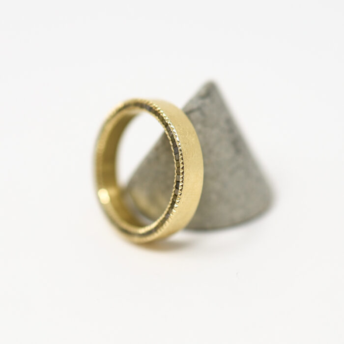 raw diamond cube and gold channel band