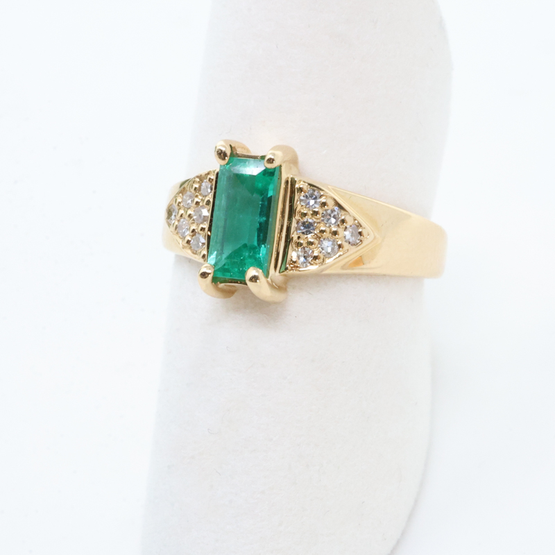 rectangular emerald and white diamond ring in yellow gold